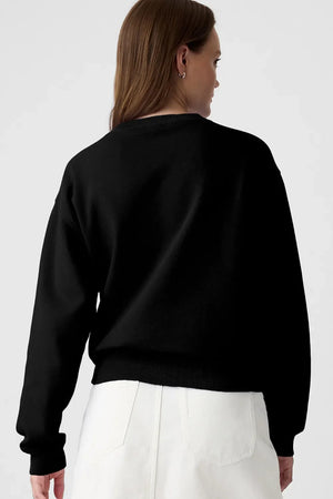 Black crewneck sweatshirt with a graphic print on the back.