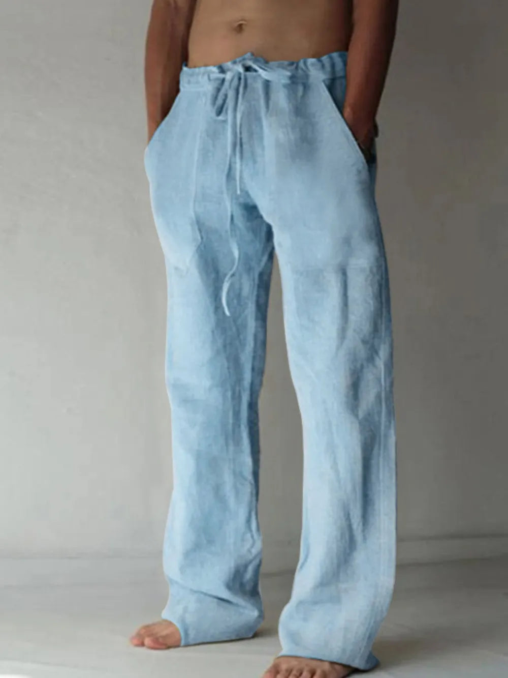 Light blue linen blend wide-leg drawstring trousers with pockets.