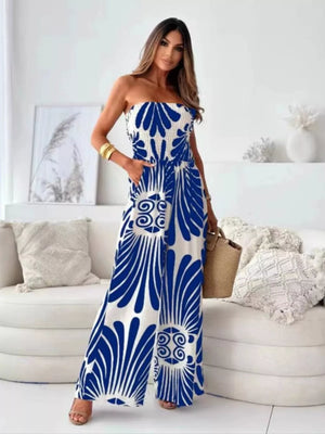 Strapless wide-leg romper in white with blue tribal print, smocked bodice, and pockets.