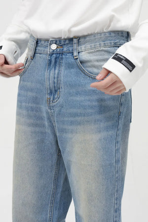 Faded wash relaxed fit jeans in medium blue denim with a casual, breathable feel.