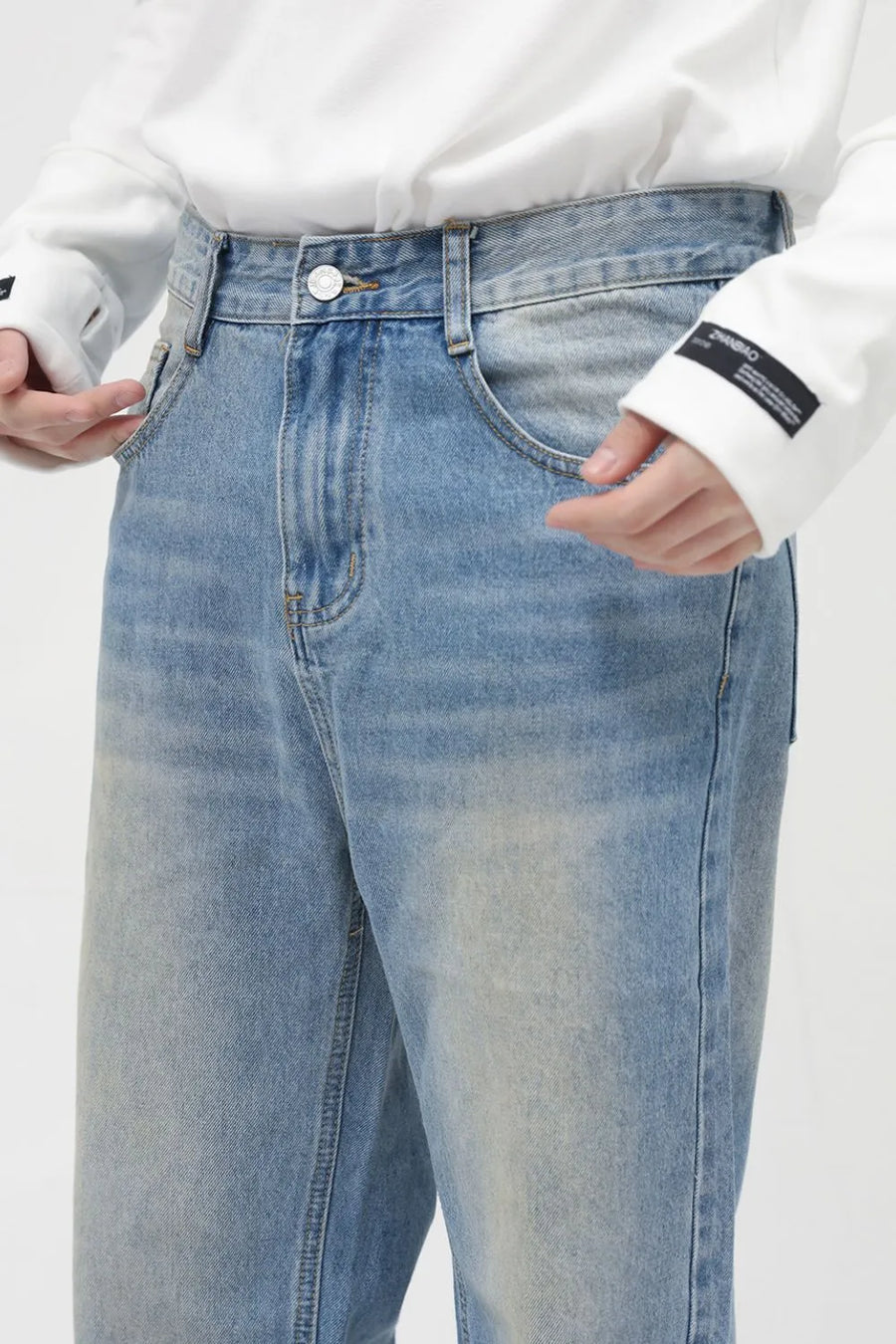 Faded wash relaxed fit jeans in medium blue denim with a casual, breathable feel.