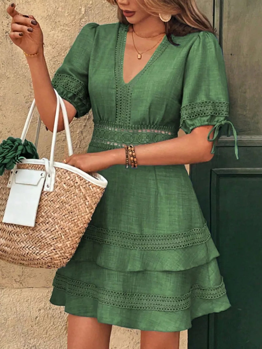 Green lace-embellished V-neck mini dress with tiered skirt and puff sleeves.