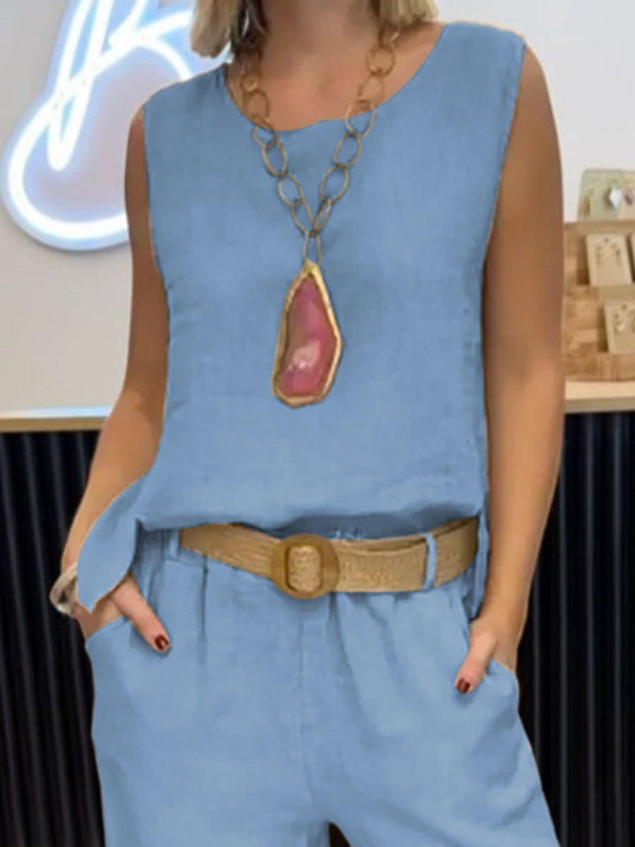 Light blue relaxed fit tank and wide-leg pants set with a straw belt and statement necklace.