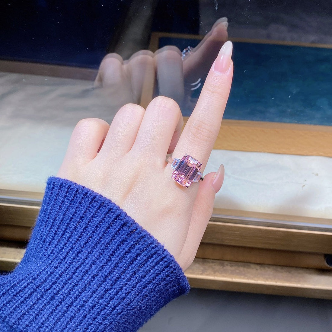 pink ring featuring geometric cut stones and geometric