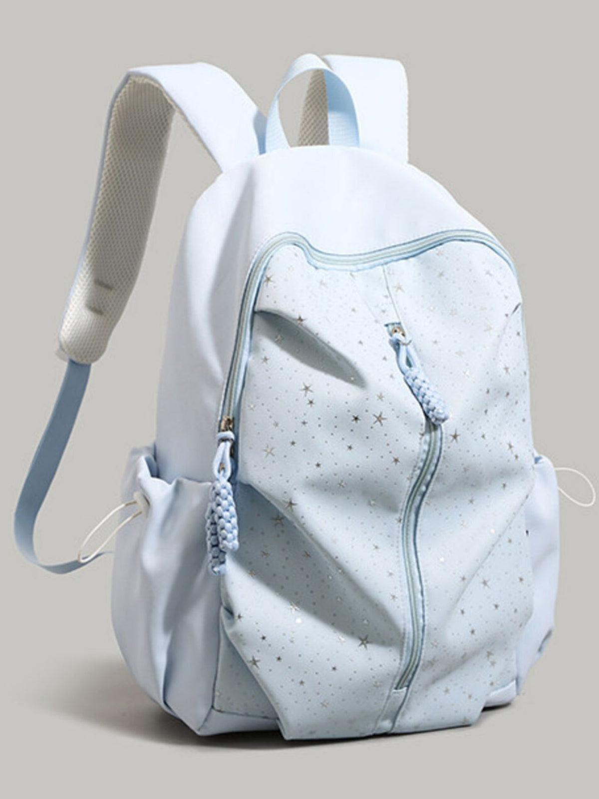 Blue nylon school backpack with scattered stars pattern and braided zipper pulls.