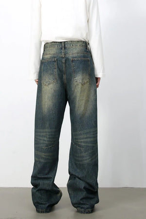 Distressed denim wide-leg trousers in medium wash, featuring a relaxed fit and vintage wash.