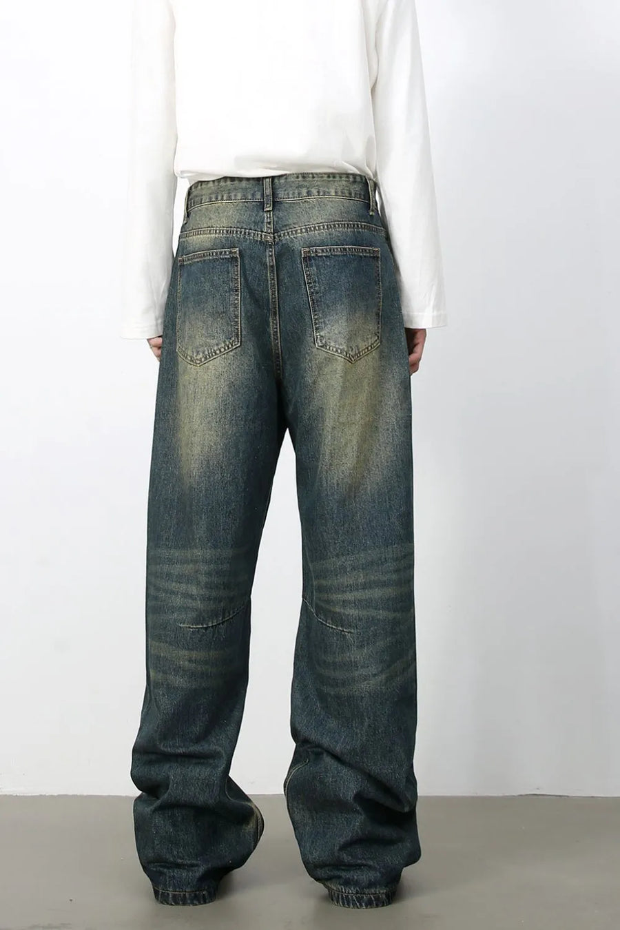 Distressed denim wide-leg trousers in medium wash, featuring a relaxed fit and vintage wash.