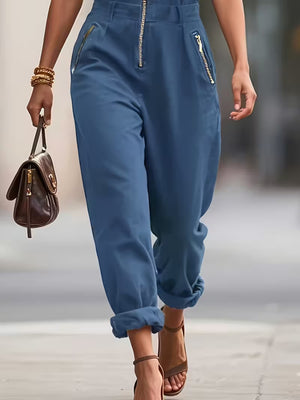 Navy blue zip-up romper with zippered pockets and cuffed ankles
