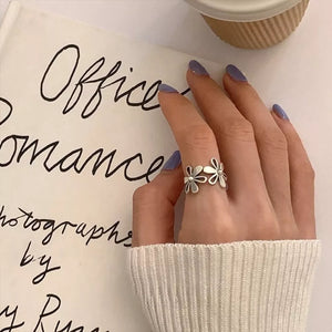Silver ring featuring open ring and floral