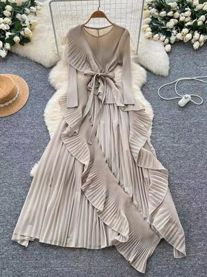 Elegant midi dress with ruffled trim, pleated skirt, and tie waist in apricot.