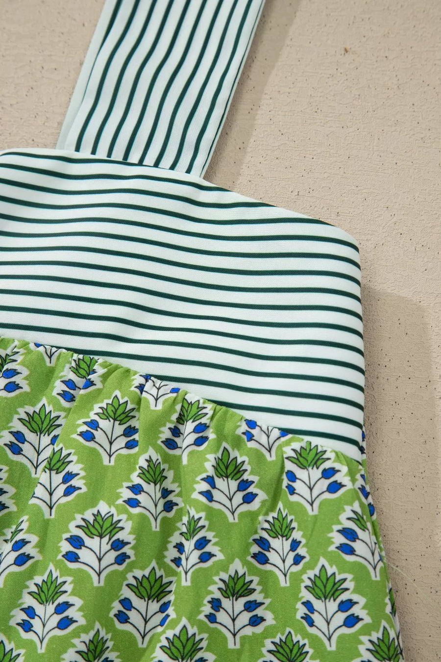Floral tie-strap tank top with square neckline, green and white stripes and blue floral print.