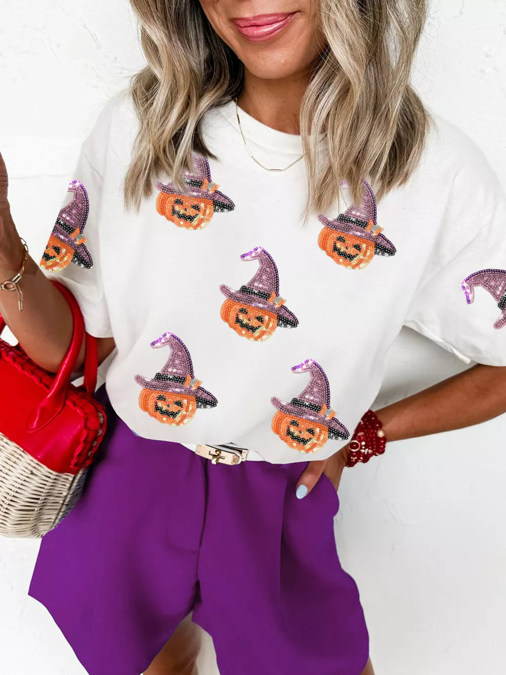 White cotton t-shirt with allover sparkling pumpkin witch graphic, crew neck, short sleeves.
