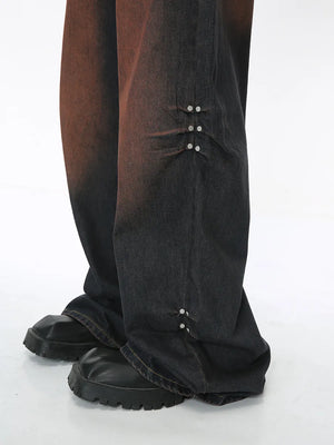 Acid wash flare jeans in dark denim with silver stud details on the leg.