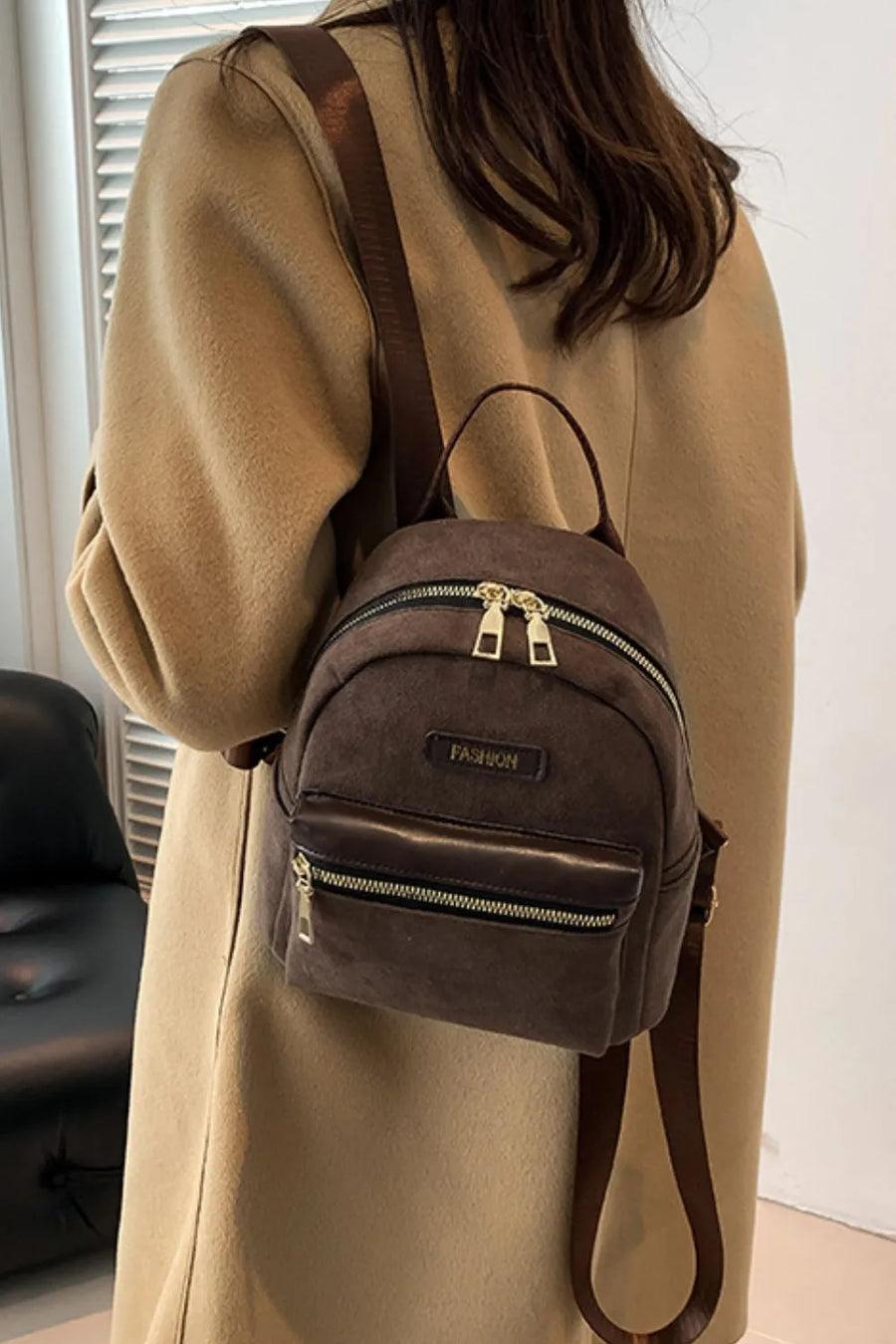 Suede mini backpack in coffee brown with golden zips and front pocket detail.