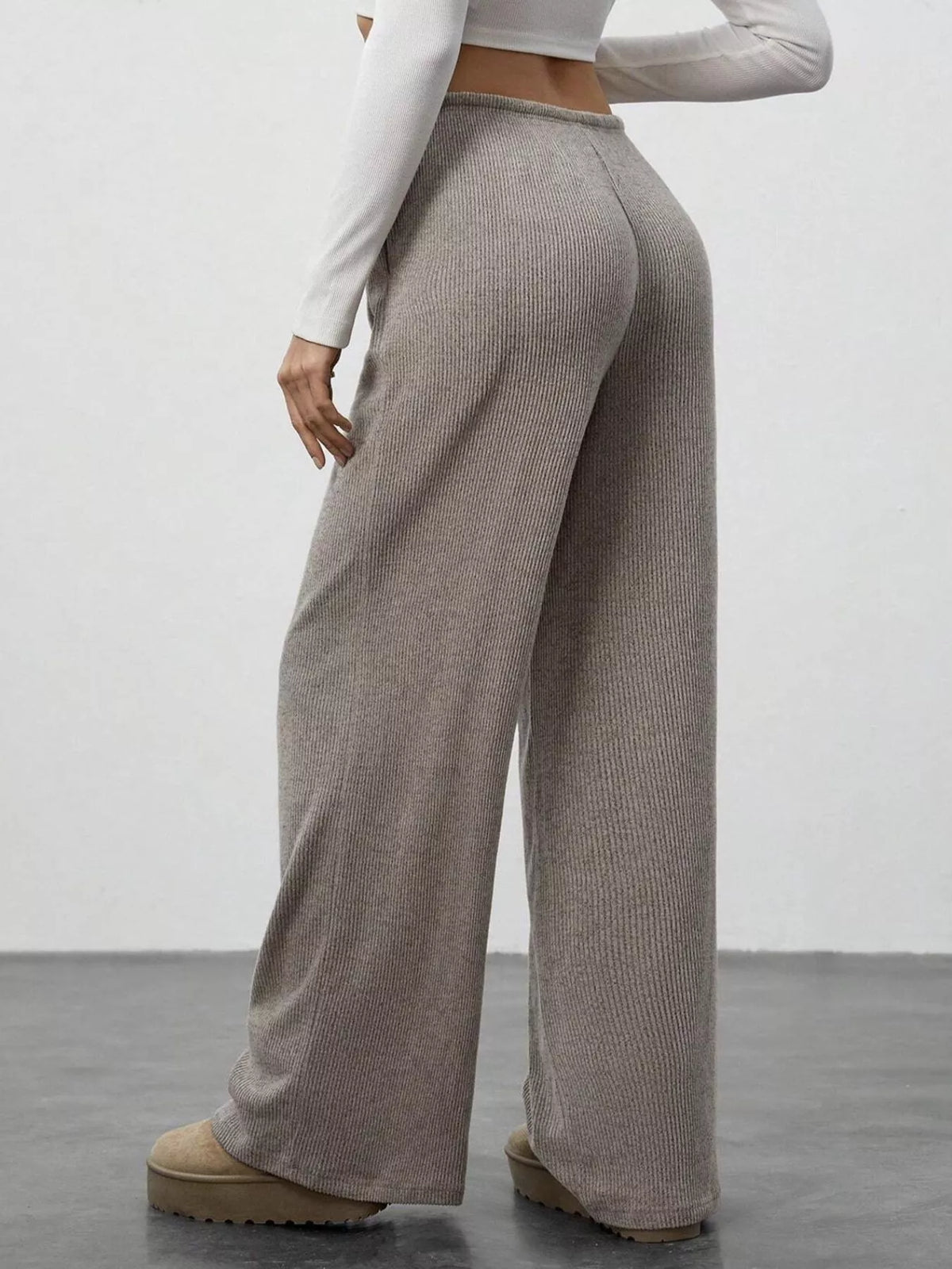 Mocha ribbed wide-leg pants with drawstring waist, shown from the back.