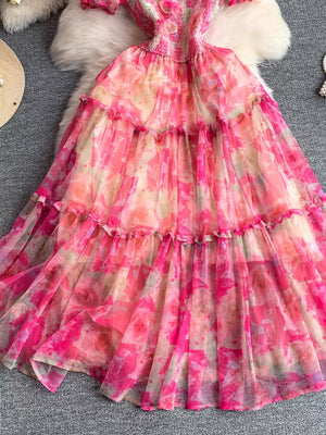 Floral tiered midi dress with smocked bodice in pink watercolor print.