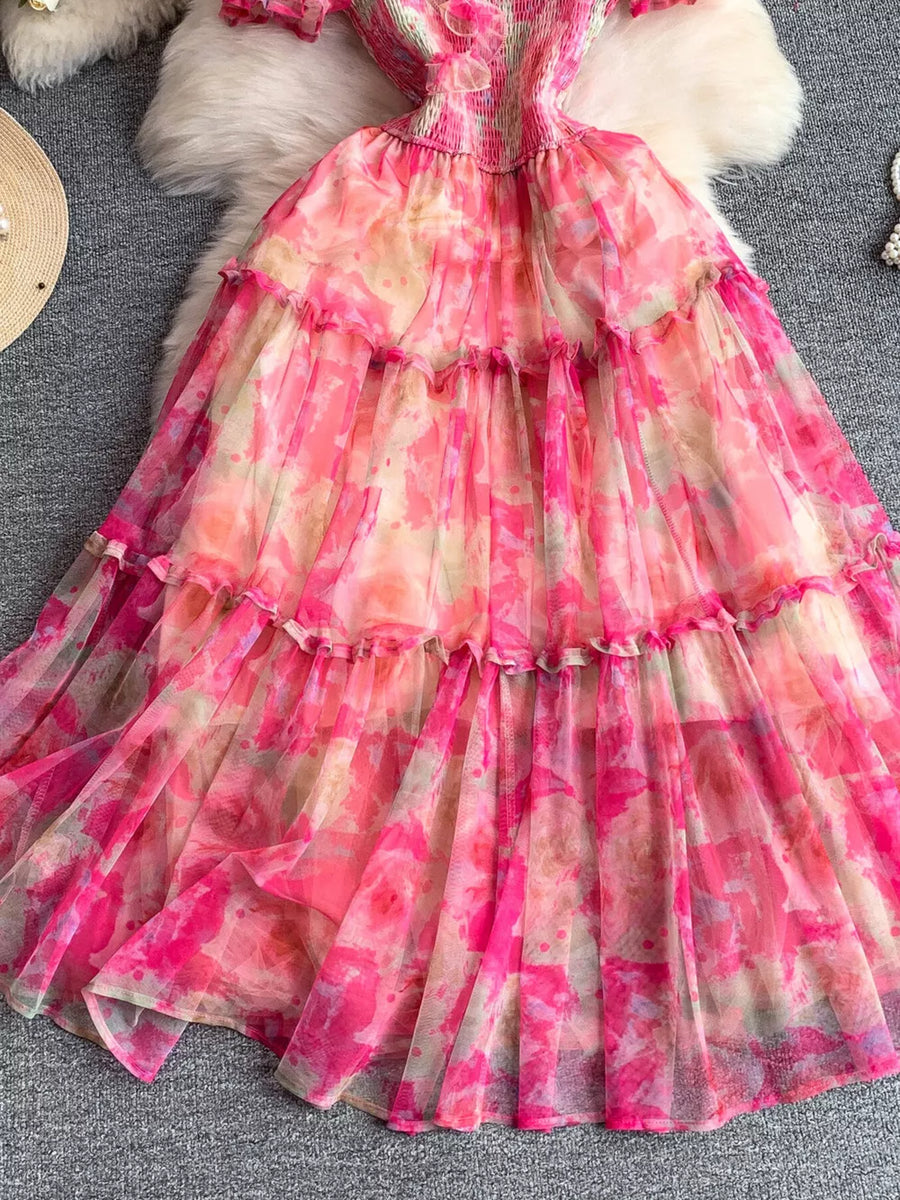 Floral tiered midi dress with smocked bodice in pink watercolor print.