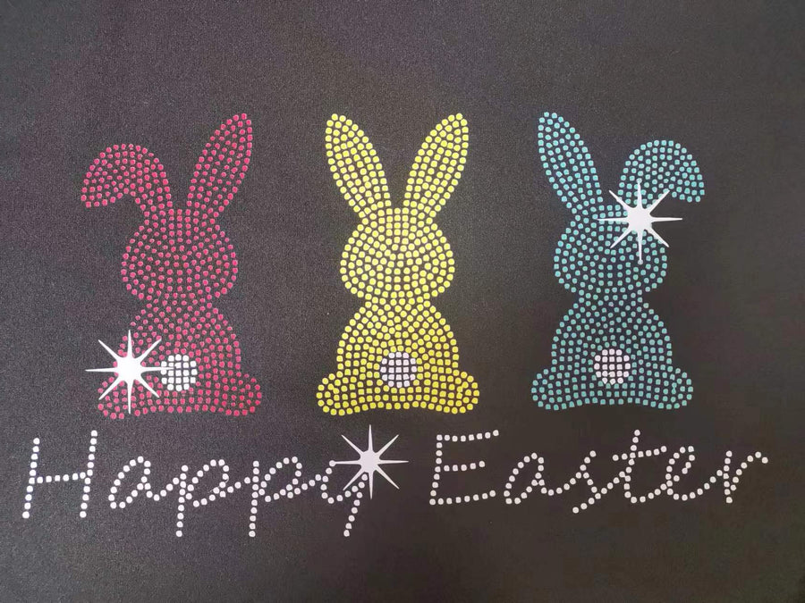 Black t-shirt with rhinestone Easter bunnies and Happy Easter text.