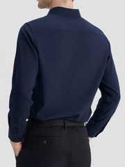 Navy long sleeve men's button-down shirt, slim fit, shown from the back.