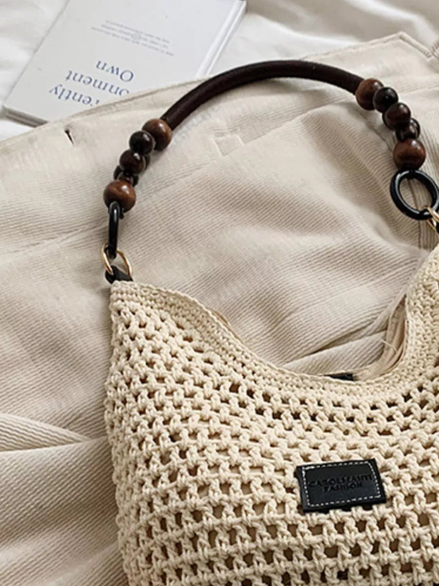 Khaki crochet tote bag with beaded handles and leather logo patch