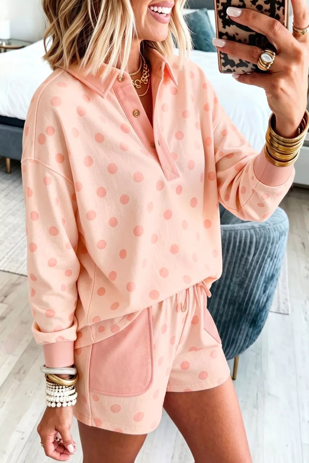 Pink polka dot lounge set with collared long sleeve top and drawstring shorts.