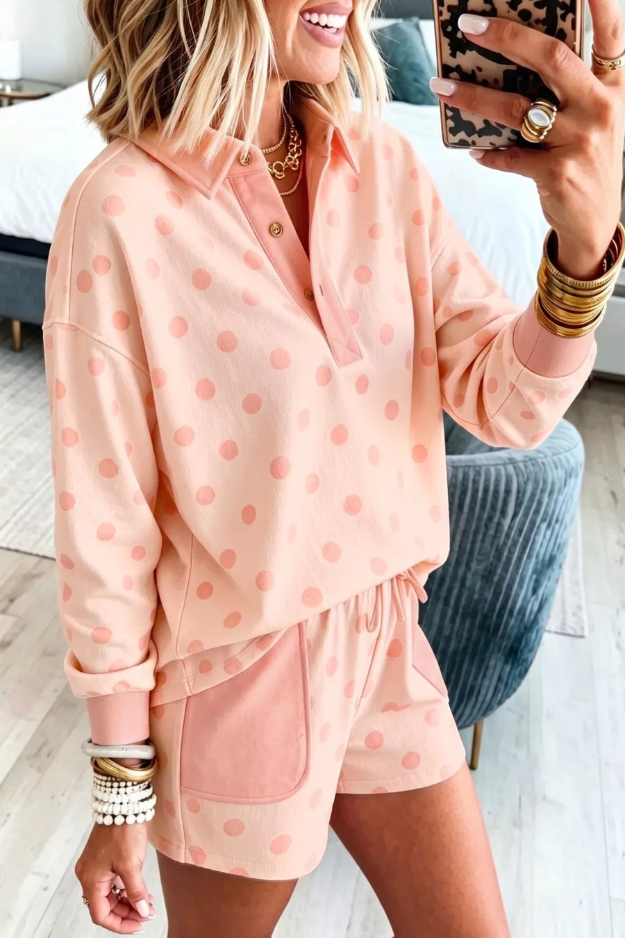 Pink polka dot lounge set with collared long sleeve top and drawstring shorts.
