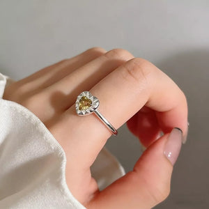 yellow ring featuring heart-shaped stone and heart-shaped