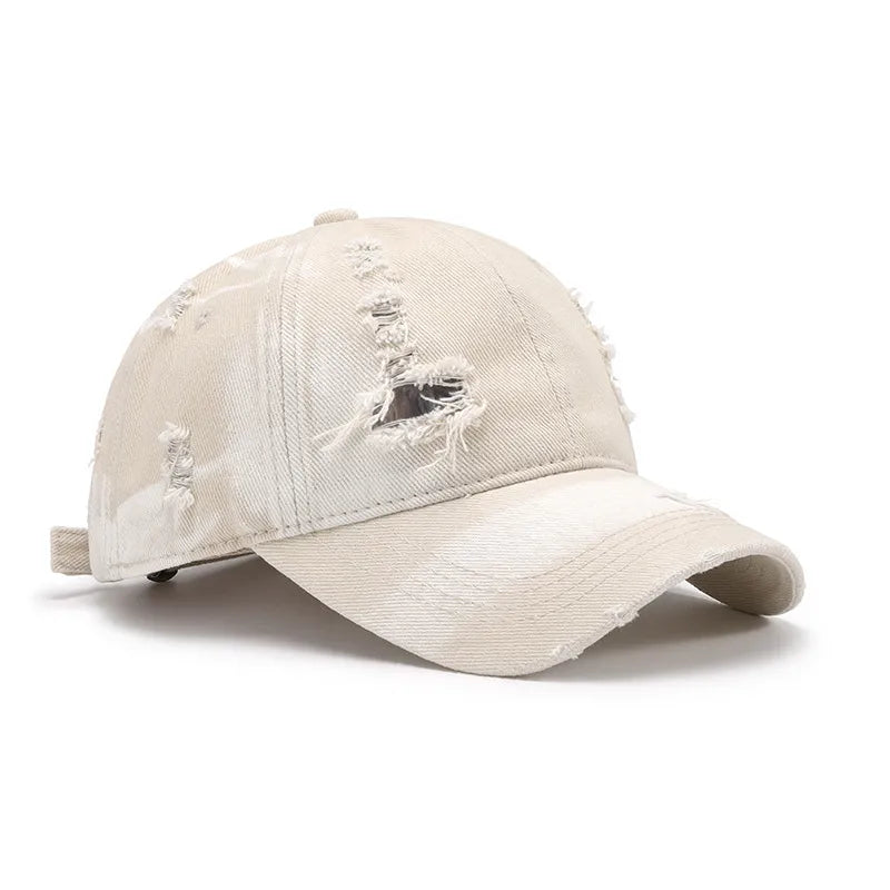 Shredded canvas baseball cap in ivory with distressed details and a curved brim.