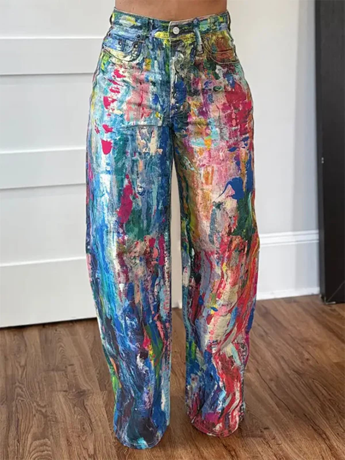 Abstract print high-waisted wide-leg cotton blend jeans with a colorful, painterly design.