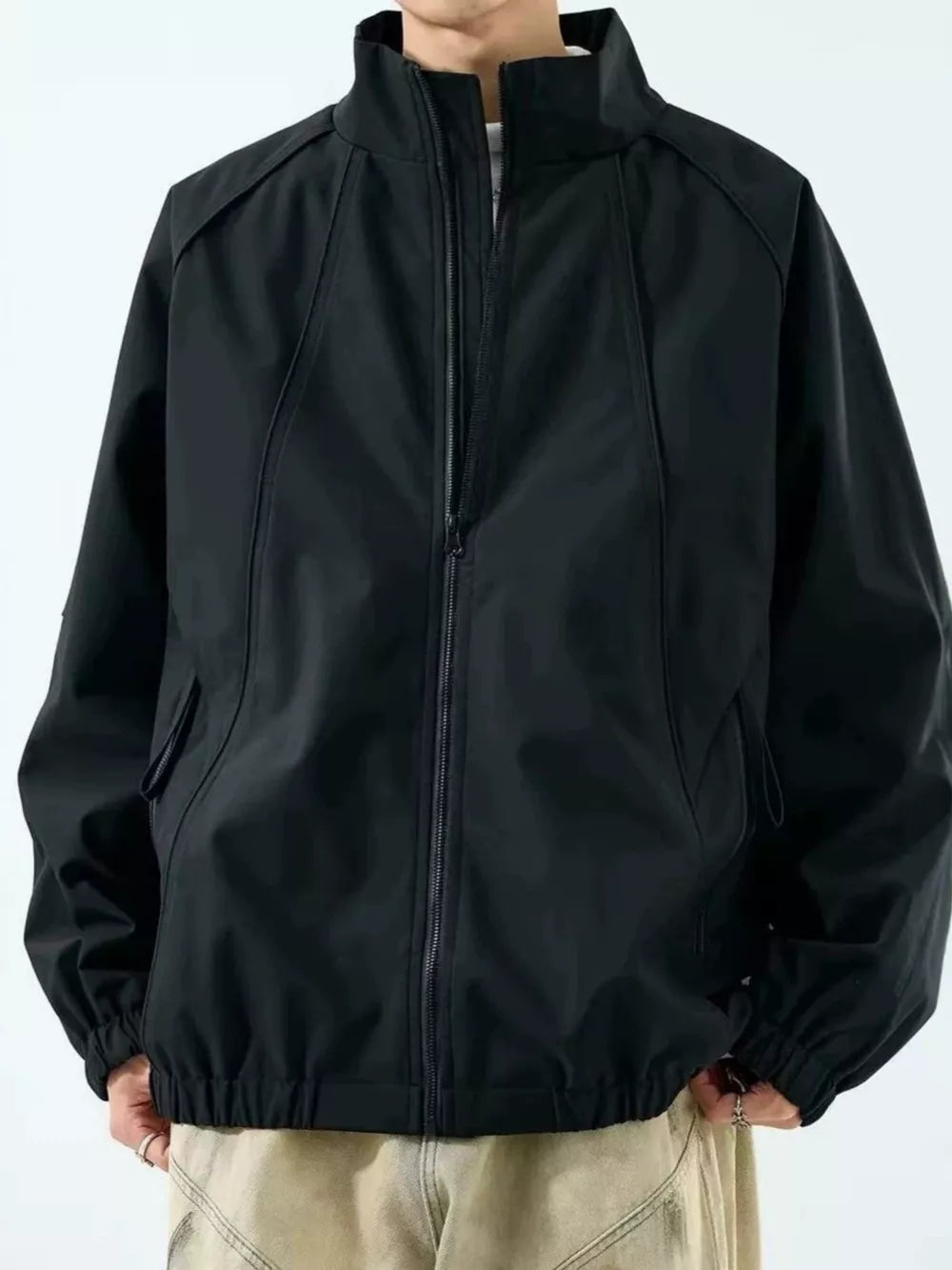 windbreaker in black featuring pocketed and relaxed fit