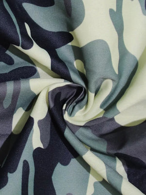 Fabric with a green, grey, and black camouflage print.