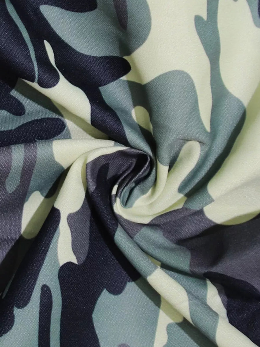 Fabric with a green, grey, and black camouflage print.