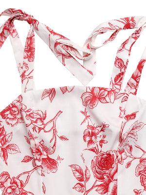 Floral tie strap maxi dress with red floral print on white fabric.