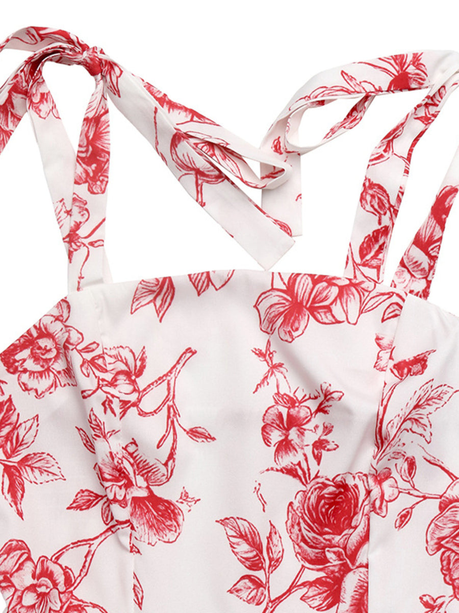 Floral tie strap maxi dress with red floral print on white fabric.