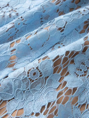 Blue lace dress fabric with intricate floral pattern detail