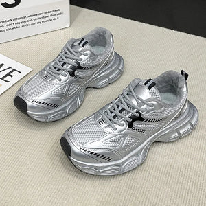 Silver lace-up athletic shoes with breathable mesh and platform soles.