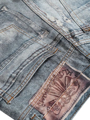 Medium wash distressed wide-leg denim jeans with a graphic back patch and contrast stitching.