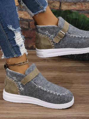 Gray textured stitch-detail buckle sneakers with white soles and tan strap.