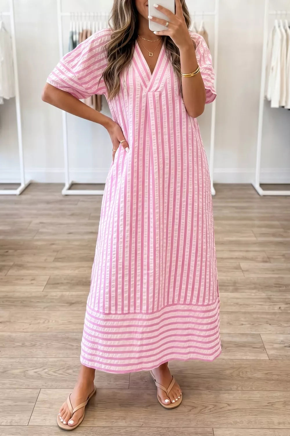Pink striped V-neck midi dress with short sleeves and a tiered hem.