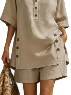 Khaki linen shorts with button detail, part of a relaxed two-piece ensemble.