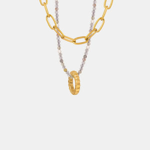 Gold layered chain necklace with beaded strand and ring pendant