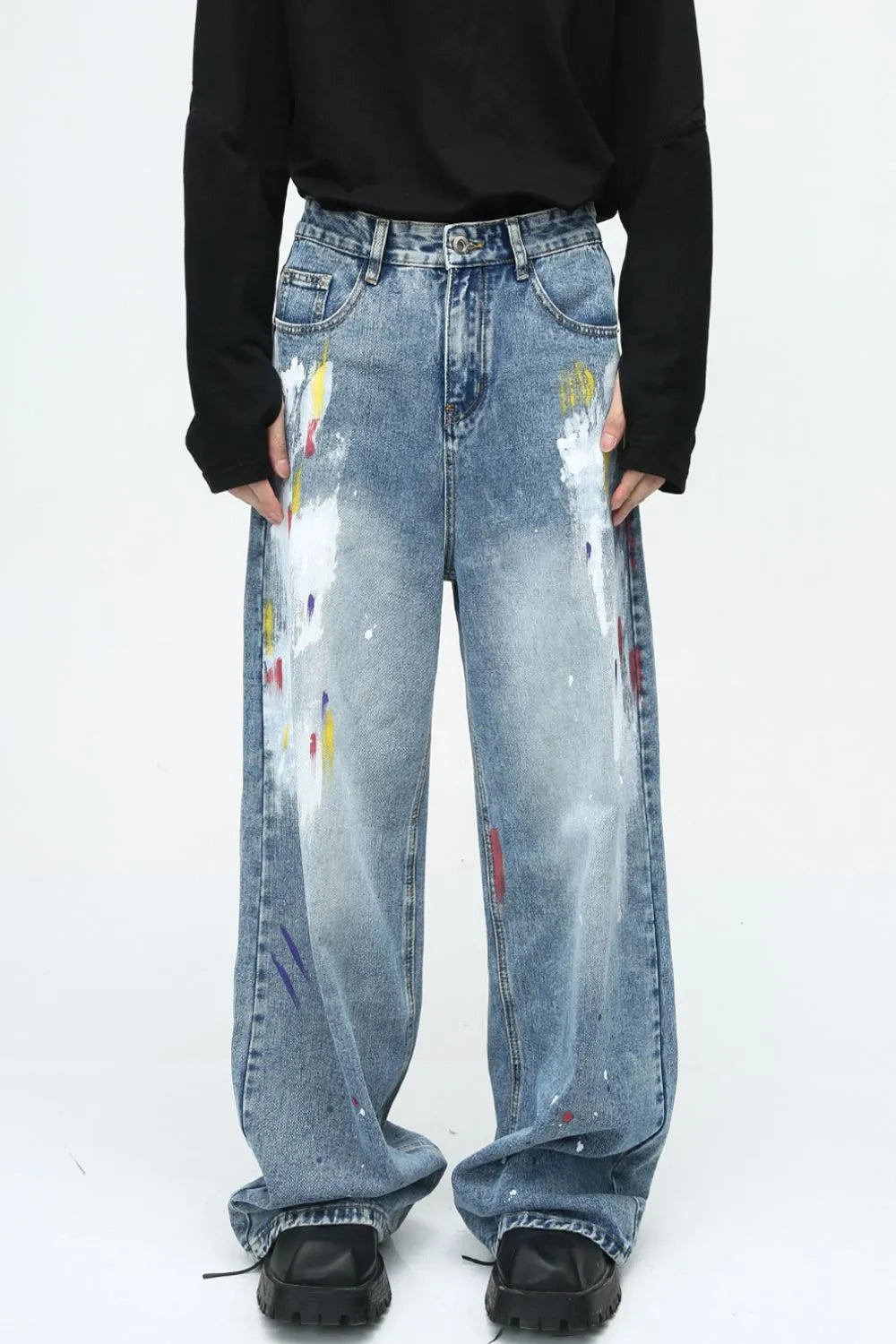 Painterly wash wide-leg denim trousers in medium blue with artistic paint splatters and a relaxed fit.