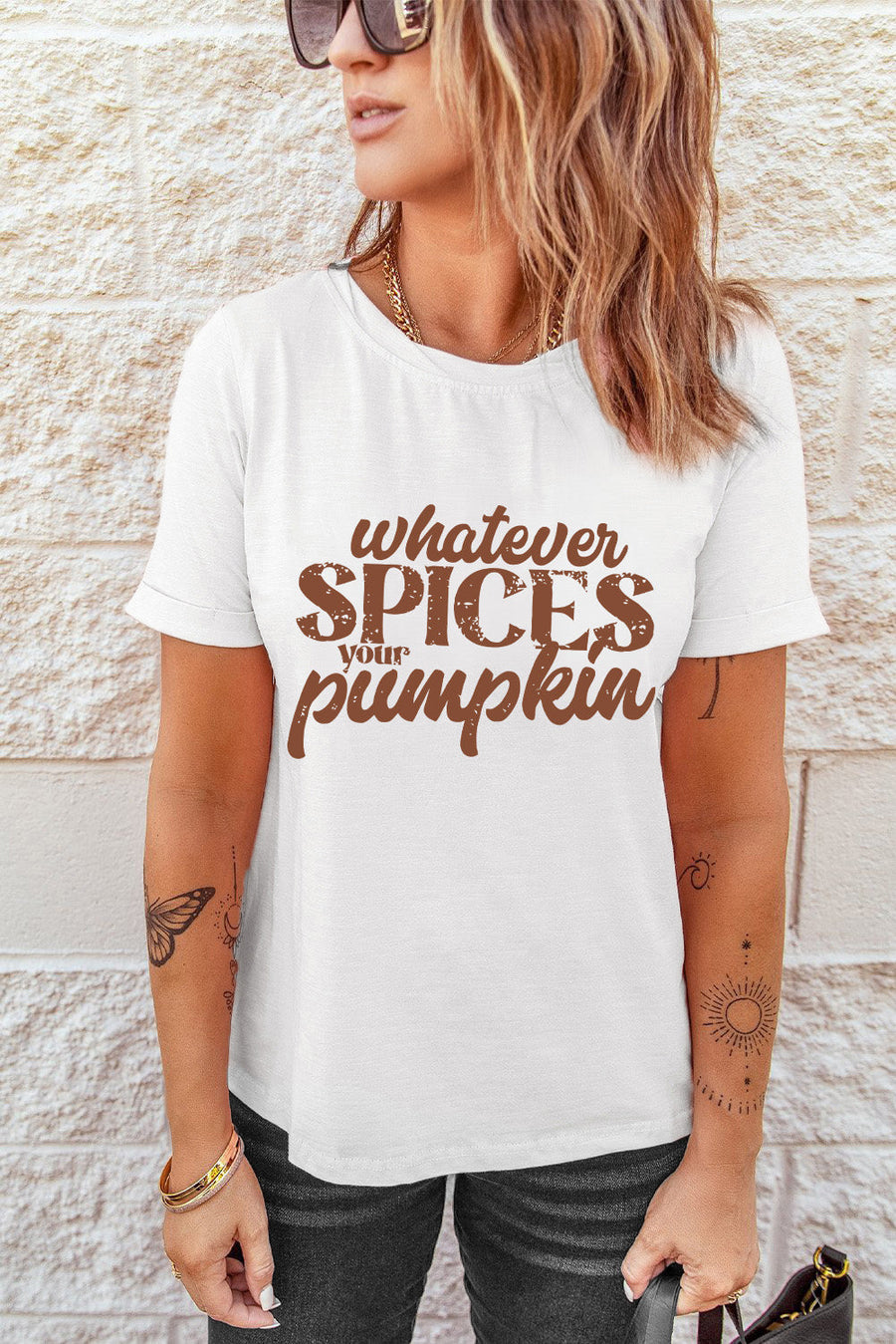 White t-shirt with brown text graphic that says "whatever spices your pumpkin