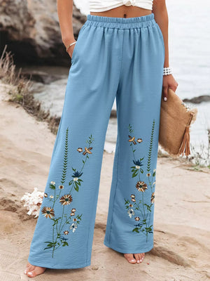 Sky blue floral wide-leg trousers with an elastic waist and embroidered flowers.