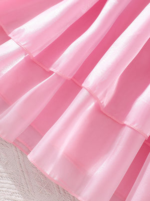 Pink baby dress with tiered ruffles and sheer organza fabric.