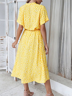 Yellow polka dot midi dress with short sleeves and cinched waist