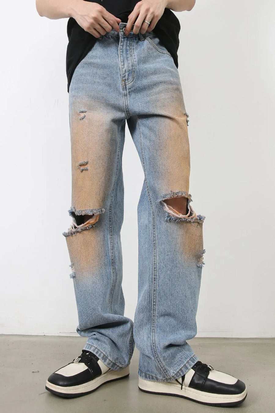 Light blue wide leg jeans with faded wash, distressed details, and ripped knees.