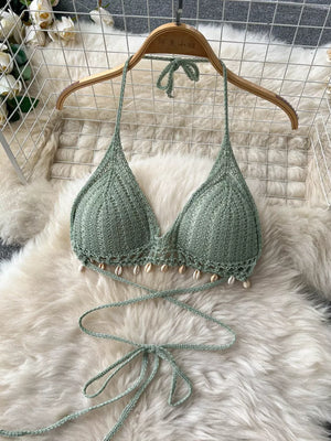 Green crochet halter bikini top with shell trim and tie closure.