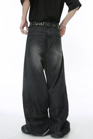Dark wash oversized denim palazzo trousers with wide legs and a distressed finish.