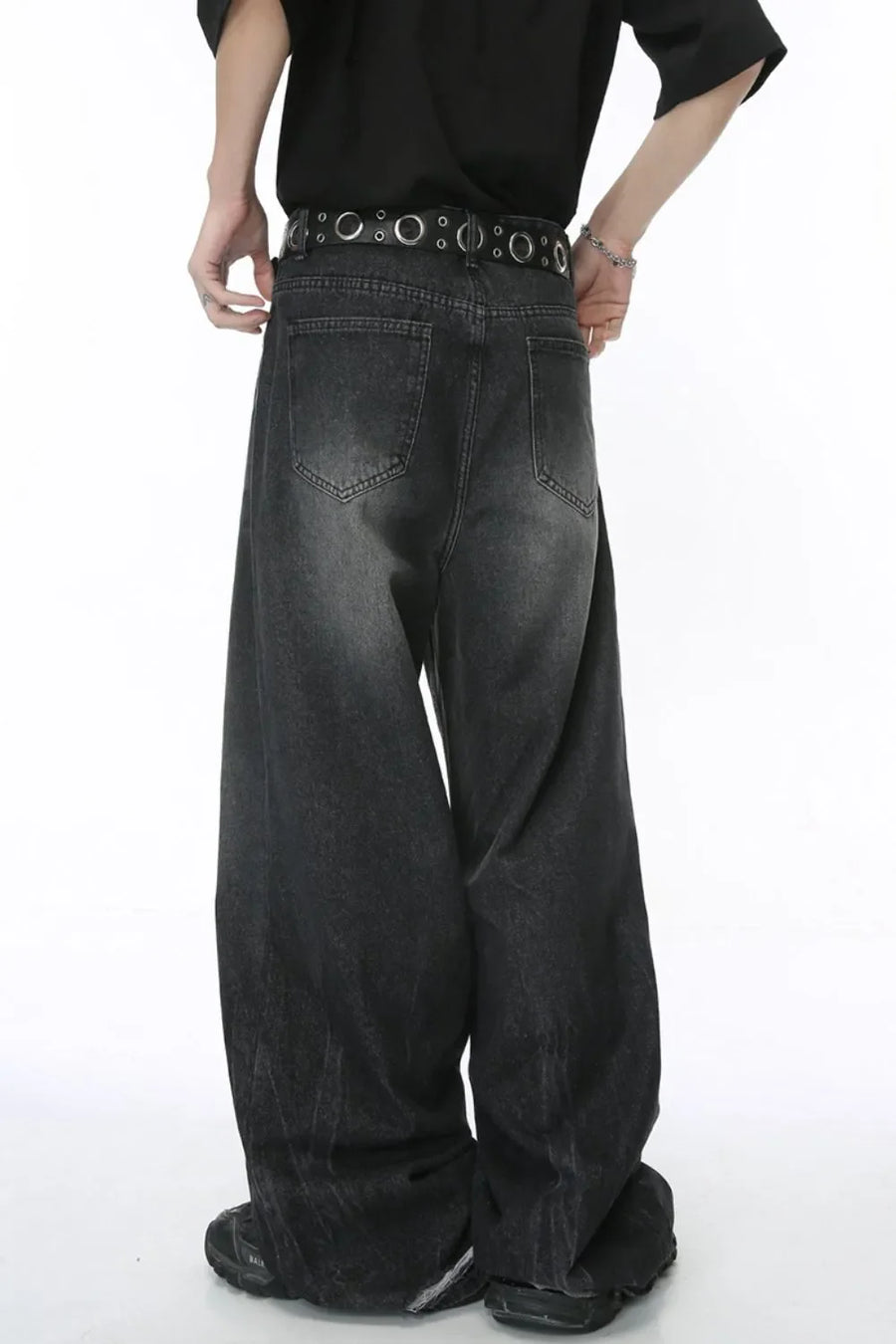 Dark wash oversized denim palazzo trousers with wide legs and a distressed finish.